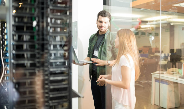 A technology professional reviewing business infrastructure with a client